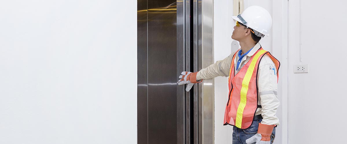man servicing lift