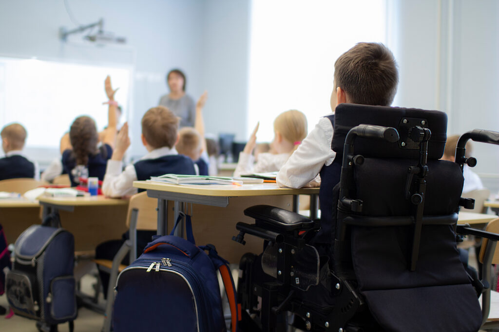 A disabled student in a wheelchair ian primary school. Socialization of the individual in society.
