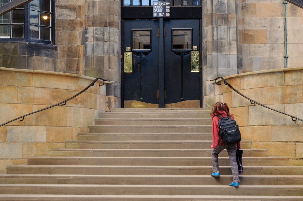 GLASGOW, SCOTLAND - MARCH 13, 2010: A student heading to the entrance of the Glasgow School of Art on March 13, 2010 in Glasgow.