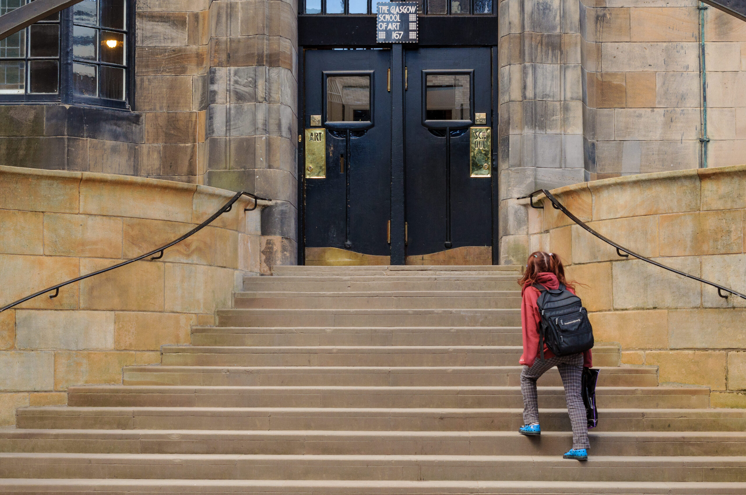 GLASGOW, SCOTLAND - MARCH 13, 2010: A student heading to the entrance of the Glasgow School of Art on March 13, 2010 in Glasgow.